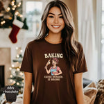 Woman wearing Baking ’Cause Murder Is Wrong Shirt, featuring a fun graphic in a cozy holiday setting.