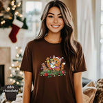 Christmas Cat / Kitten Playing With Lights Shirt worn by a smiling woman in a cozy setting with festive decor.