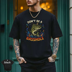 Model wearing a black 'Don't Be a Basshole Shirt' featuring vibrant fish graphic and modern fit.