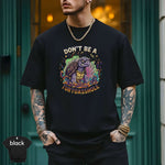 Model wearing a black shirt with the text 'Don’t Be a Turtoasshole' and colorful graphic design by Lucky Spark.