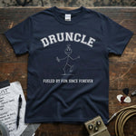 Druncle – Fueled by Fun Since Forever Shirt displayed on a wooden surface with guitar picks and gear.