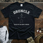 Druncle – Fueled by Fun Since Forever Shirt displayed on a wooden table with music accessories.