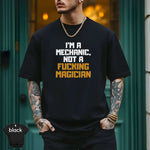 I'm a Mechanic, Not a F**ing Magician Shirt displayed by a model in a stylish urban setting, showcasing premium quality textile.