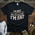I’m Not Pregnant, I’m Fat Shirt displayed on a black background with guitar accessories.