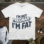 I’m Not Pregnant, I’m Fat Shirt displayed on a wooden surface with accessories, showcasing its vibrant print and modern fit.