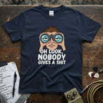Oh Look, Nobody Gives a Shit Shirt displayed on wood table with binocular graphic, featuring lucky spark design.