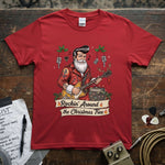 Rockin’ Around the Christmas Tree - Rockabilly Santa Shirt on a red tee, featuring a festive Santa playing guitar.