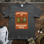 Santa Checked My Pedalboard Twice Shirt on a gray tee with vibrant graphic and festive lights.