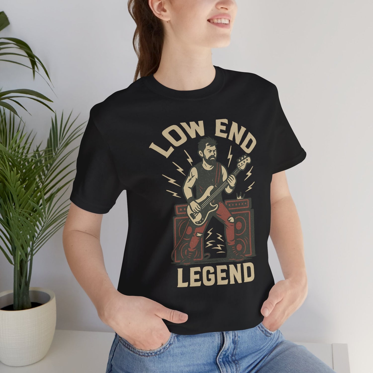 A woman wearing a Low End Legend t-shirt