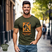 Rock Out With My **** Out | Funny Guitar Rock Music T-Shirt featuring a man in military green tee playing guitar outdoors.