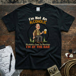 I’m Not An Alcoholic I’m At The Bar | Funny Drinking Humor T-Shirt with cartoon character holding a beer.