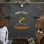 Don't Be a Basshole Shirt displayed on a gray tee with a vibrant fish graphic and colorful text.
