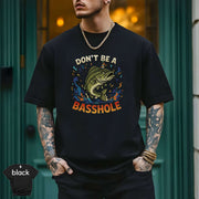 Model wearing a black 'Don't Be a Basshole Shirt' featuring vibrant fish graphic and modern fit.