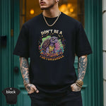 Model wearing a black shirt with the text 'Don’t Be a Turtoasshole' and colorful graphic design by Lucky Spark.