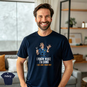 I Know What I’m Doing I Just Don’t Know Why | Funny Mechanic T-Shirt worn by smiling man in a navy tee at home.