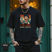 I Fix Cars Because I’m Hopeless at Relationships | Funny Mechanic T-Shirt worn by a man with tattoos against a stylish background.
