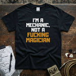 I'm a Mechanic, Not a F**ing Magician Shirt displayed on a premium black tee with bold text.