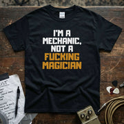 I'm a Mechanic, Not a F**ing Magician Shirt displayed on a premium black tee with bold text.