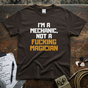 I'm a Mechanic, Not a F**ing Magician Shirt displayed on a brown tee with vibrant text design.