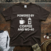 Powered by Coffee and WD-40 Shirt on a brown tee with coffee and WD-40 graphics.