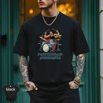 Professional Noisemaker | Funny Drummer Musician Shirt worn by a stylish man with tattoos, sporting a bold drumming design.