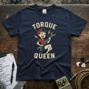 Torque Queen Shirt displayed on a navy tee with a vintage cartoon design featuring a girl holding a wrench.
