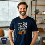 Trust Me I’m Almost a Doctor for Cars | Funny Mechanic T-Shirt modeled by a smiling man in a navy tee.