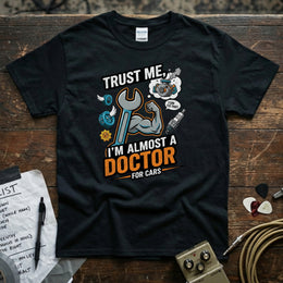 Trust Me I’m Almost a Doctor for Cars | Funny Mechanic T-Shirt featuring a wrench and humorous graphics.