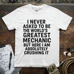 World’s Greatest Mechanic Shirt displayed on a wooden table with musical accessories.