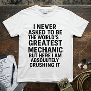 World’s Greatest Mechanic Shirt displayed on a wooden table with musical accessories.